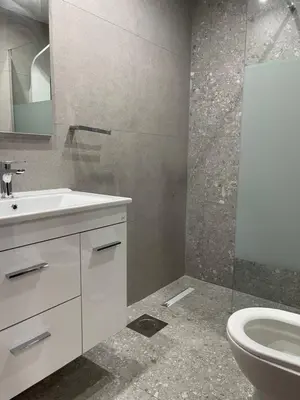 a bathroom with a white sink and a toilet at Pervolia Oasis Villa in Kiti