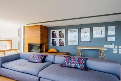 a blue living room with a blue couch with pillows at The Loft Penthouse in the Heart of City Center in Nicosia