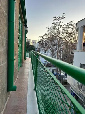 a green railing on a balcony of a building at city center accommodation in Nicosia