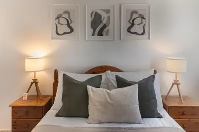 a bedroom with a bed with two lamps and two pillows at Phaedrus Living Seaview Phinikoudes Flat in Larnaka
