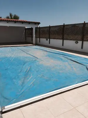 a large swimming pool on the side of a building at Erini Villa in Protaras