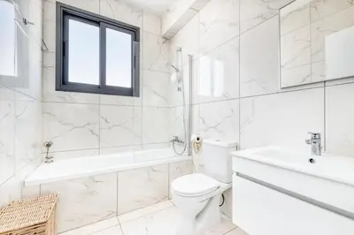 a white bathroom with a toilet and a sink at Luxurious Villa Alasia in Paralimni in Paralimni