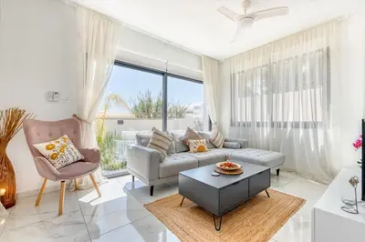 a living room with a couch and a table at Luxurious Villa Alasia in Paralimni in Paralimni