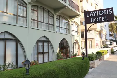 a hotel sign in front of a building at Layiotis Hotel in Larnaka