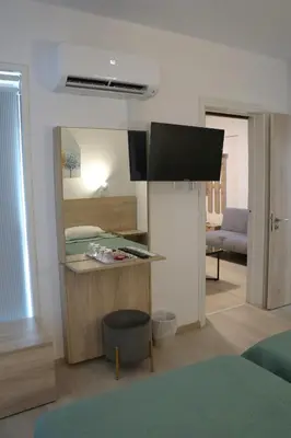 a room with a bedroom with a bed and a mirror at Layiotis Hotel in Larnaka