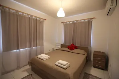a bedroom with two beds with towels on them at Near the Beach Holiday Apartment in Limassol