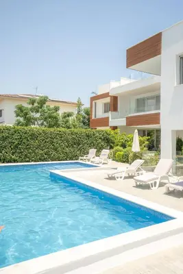 a villa with a swimming pool and a house at Hubstay Tamara Gardens 2 Bed Apt Suite with Pool in Livadhia