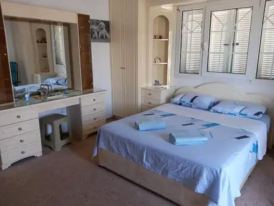 a bedroom with a bed and a sink and a mirror at Vasilis family room in Mor Menekshe