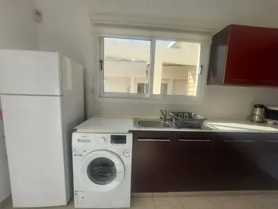 a kitchen with a washing machine and a sink at Central 1 bedroom lux apartment in Larnaka