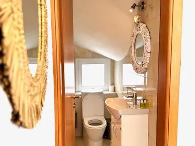 a bathroom with a toilet and a sink and a mirror at Hephaestus Family Villa, Ayia Triada Beach in Paralimni