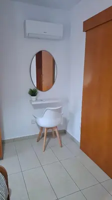 a bathroom with a white tub and a mirror at By The Way Apartment 1 in Larnaka