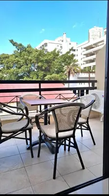 a patio with a table and chairs on a balcony at By The Way Apartment 1 in Larnaka