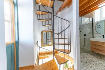 a spiral staircase in a bathroom with a sink at 1927 Heritage House - Indoor Garden , Old City in Nicosia