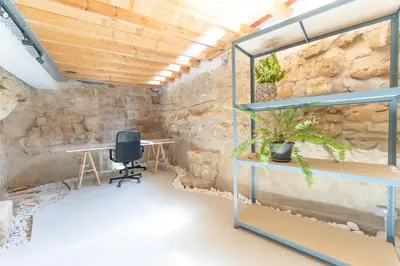 a stone walled room with a desk and a chair at 1927 Heritage House - Indoor Garden , Old City in Nicosia