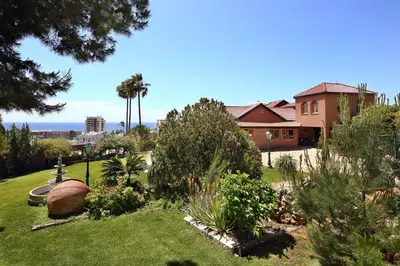 a yard with a house and a garden with plants at Olive Tree Apartments in Limassol