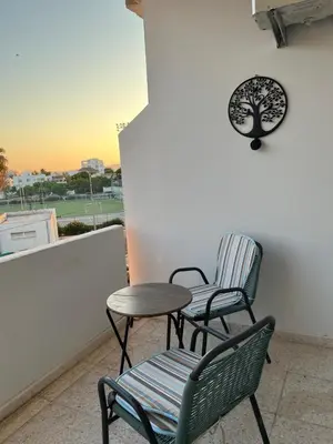 two chairs and a table on a balcony at Tower Court rooms in Larnaka