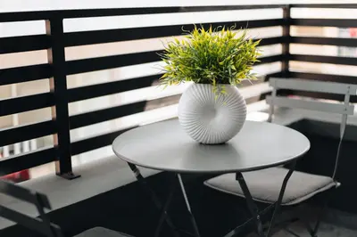 a white vase sitting on a table with a plant at Kition Urban Suite 1 in Larnaka