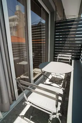 a table and two chairs on a balcony at Kition Urban Suite 1 in Larnaka