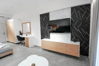 a living room with a black and white marble wall at Kition Urban Suite 1 in Larnaka