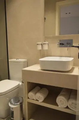 a bathroom with a sink and a toilet and a mirror at LEONDIANA Boutique Hotel in Larnaka