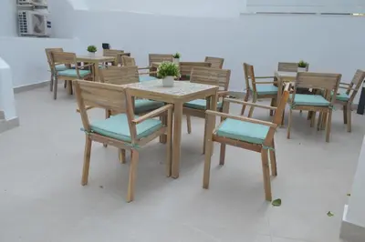 a dining room with wooden tables and chairs at LEONDIANA Boutique Hotel in Larnaka