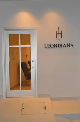 a sign on the wall of a building with a door at LEONDIANA Boutique Hotel in Larnaka