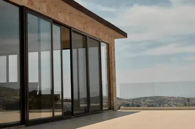 a building with glass windows with a view at Kleos Noble Retreat - Private Estate in Limassol