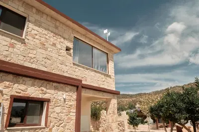 a stone house with a view of a mountain at Kleos Noble Retreat - Private Estate in Limassol