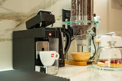 a counter top with a coffee maker and a cup at SuiteNapa22 in Ayia Napa