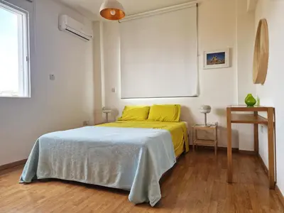 a bedroom with a bed with a yellow blanket at STAY Space View Apartment in Nicosia