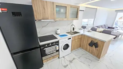 a kitchen with a stove top oven next to a dishwasher at Urban Comfort Apartment in Larnaka