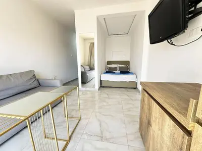 a living room with a couch and a bed at Alice Studio Holiday Apartment - Ayia Napa in Ayia Napa
