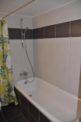 a bathroom with a bath tub with a shower at Niove Budget One-Bedroom Apartment in Paralimni