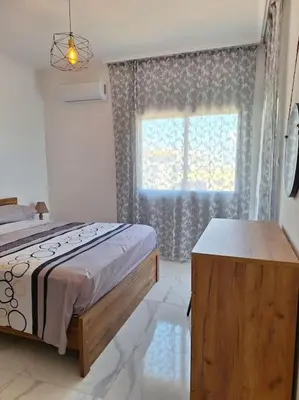 a bedroom with a bed and a large window at Luxury one bedroom - seafront in Limassol