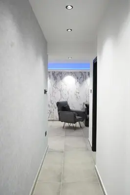 a living room with a chair and a couch at Lazuli Urban Luxury -2 bedroom with Pool in Larnaka