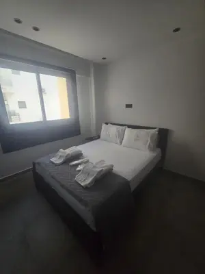 a bedroom with a bed with two towels on it at Lazuli Urban Luxury -2 bedroom with Pool in Larnaka