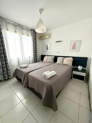 a bedroom with a bed with two towels on it at Irenes Apartment in Larnaka