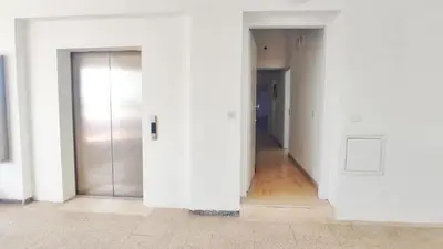an empty room with white walls and a door at Stunning Top-Floor Beachfront Apartment in Larnaka