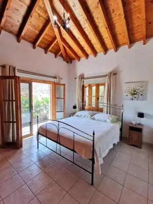 a bedroom with a bed in a room with windows at Wedding Unique Villa in Larnaka