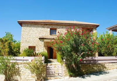 a stone house with flowers in front of it at Wedding Unique Villa in Larnaka