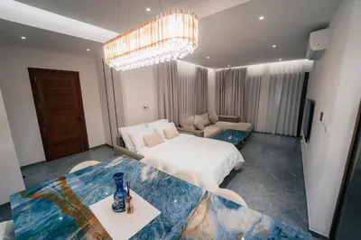 a bedroom with a bed and a table with a vase on it at TG NEW Luxury Private Resort & SPA Villas - Heated Salty Swimming Pool, Outdoor Jacuzzi, Sauna, Exotic Garden in Limassol