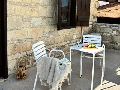 two chairs and a table with a plate of fruit at Levanda House - Traditional House Vasa Koilaniou in Vasa Kilaniou