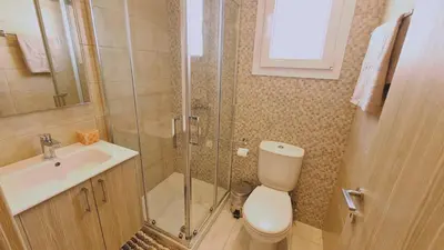 a bathroom with a toilet and a sink and a shower at STAY Novel Apartment in Larnaka