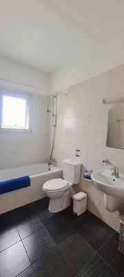 a bathroom with a toilet and a tub and a sink at Crystal aptmnt next to the beach in Protaras