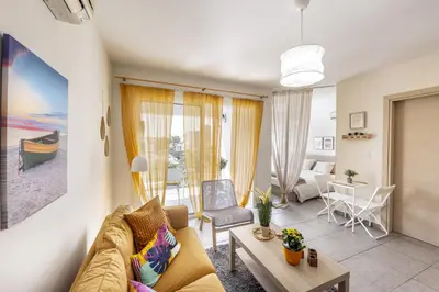 a living room with a couch and a table at STAY Sunflower Delight Studio in Nicosia