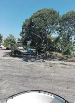 a view of a parking lot with a tree at Sweet Home by the sea in Pyla
