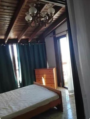 a bedroom with a bed and a dresser and window at Sweet Home by the sea in Pyla