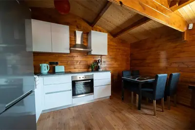 a kitchen with a stove and a table with chairs at Ktima To Alliotiko - Lofou 2 in Lofou