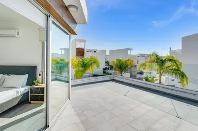 a balcony with a bed and a view of the city at Villa Elite Blu by Ezoria Villas in Ayia Napa