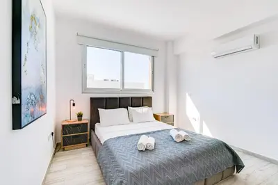 a bedroom with a bed with two towels on it at Villa Elite Blu by Ezoria Villas in Ayia Napa